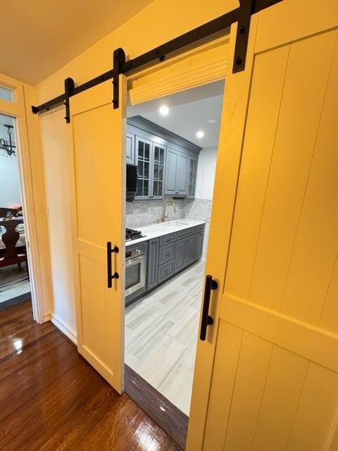 We Transformed a tiny Galley Kitchen in Astoria, Queens using Barn doors to create more of an open concept 